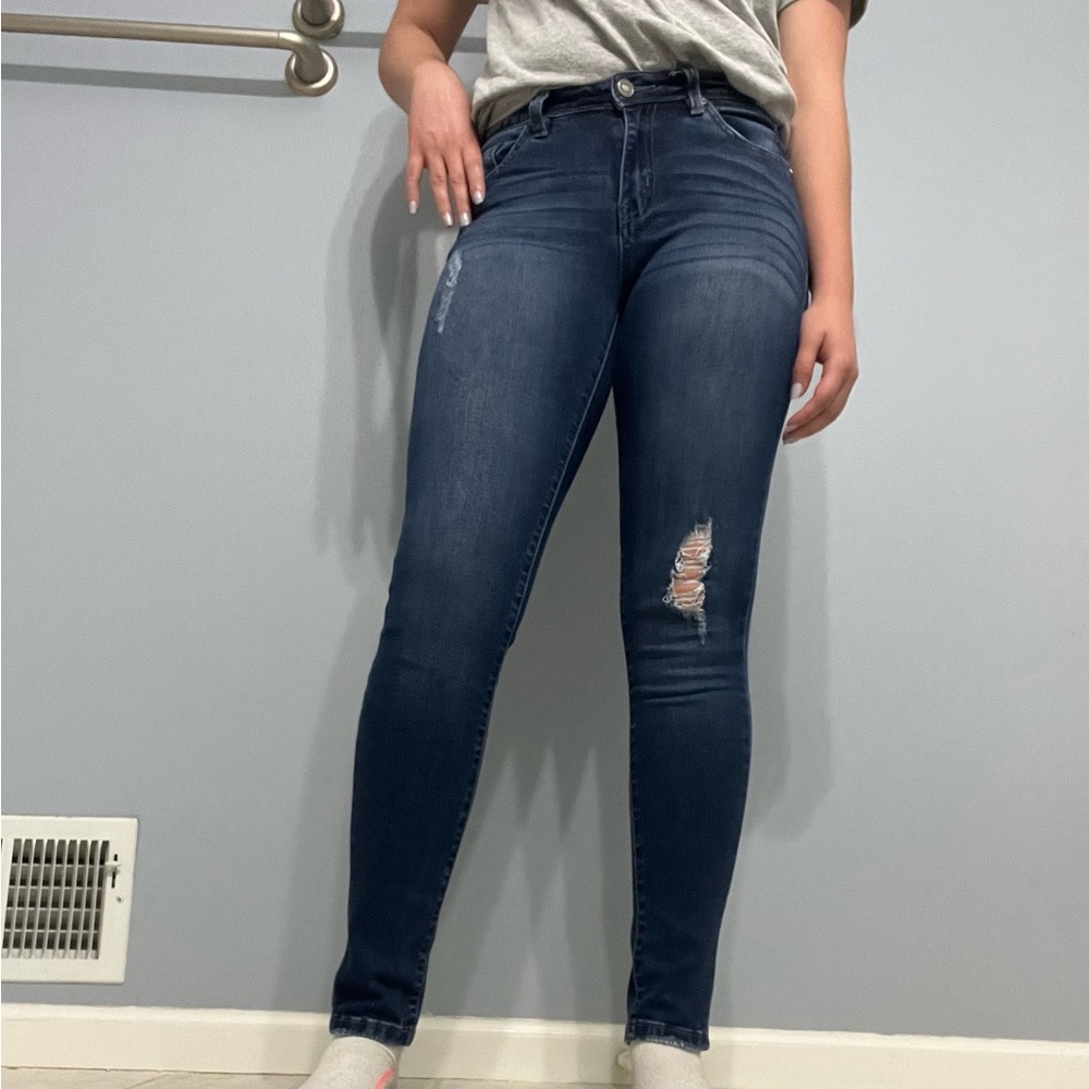 Low cut, slightly, ripped blue jeans